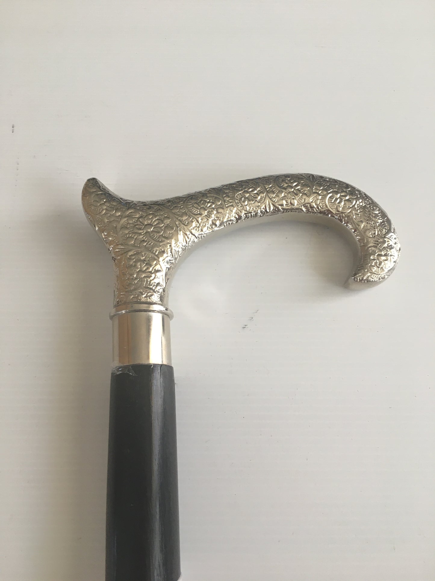 Walking Stick with Silver Goats Horn Handle on a plain Black Stick