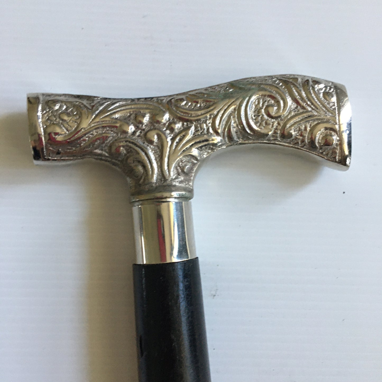 Walking Stick with comfortable T shape silver handle on plain black stick