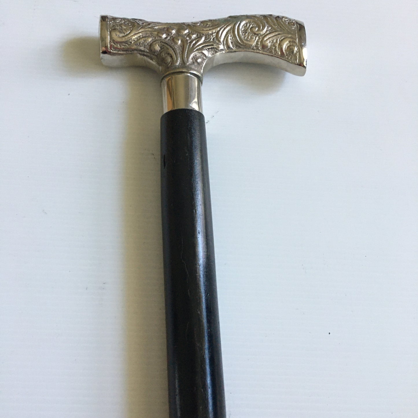 Walking Stick with comfortable T shape silver handle on plain black stick